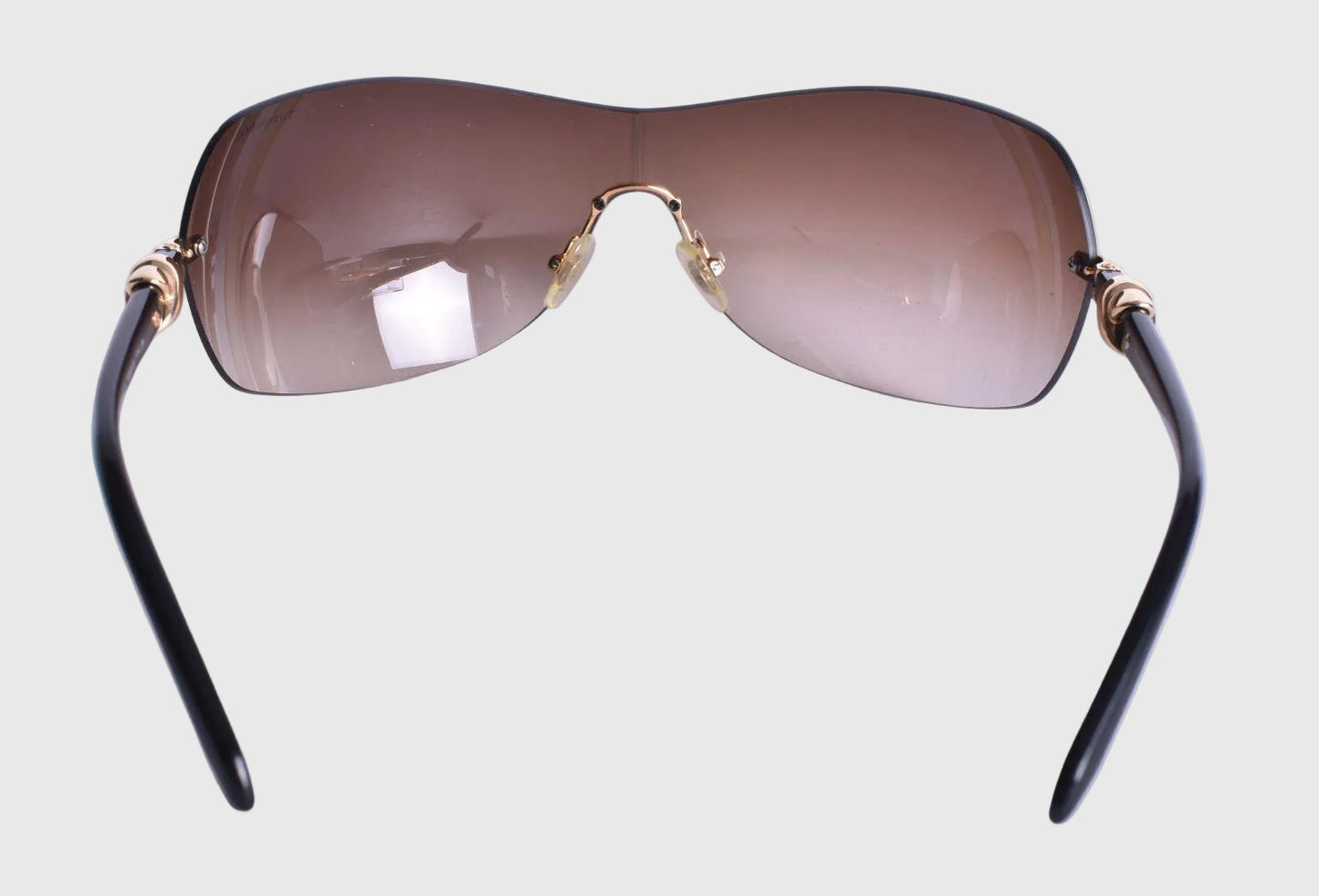 Sunglasses with brown lenses and black frames on a white background