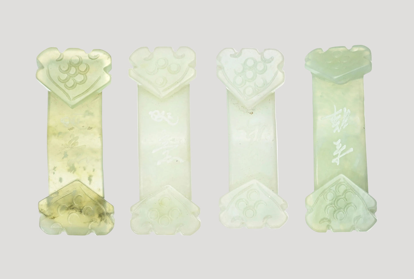Set of 4 antique jade belt buckles, each adorned with two ruyi, with inscriptions