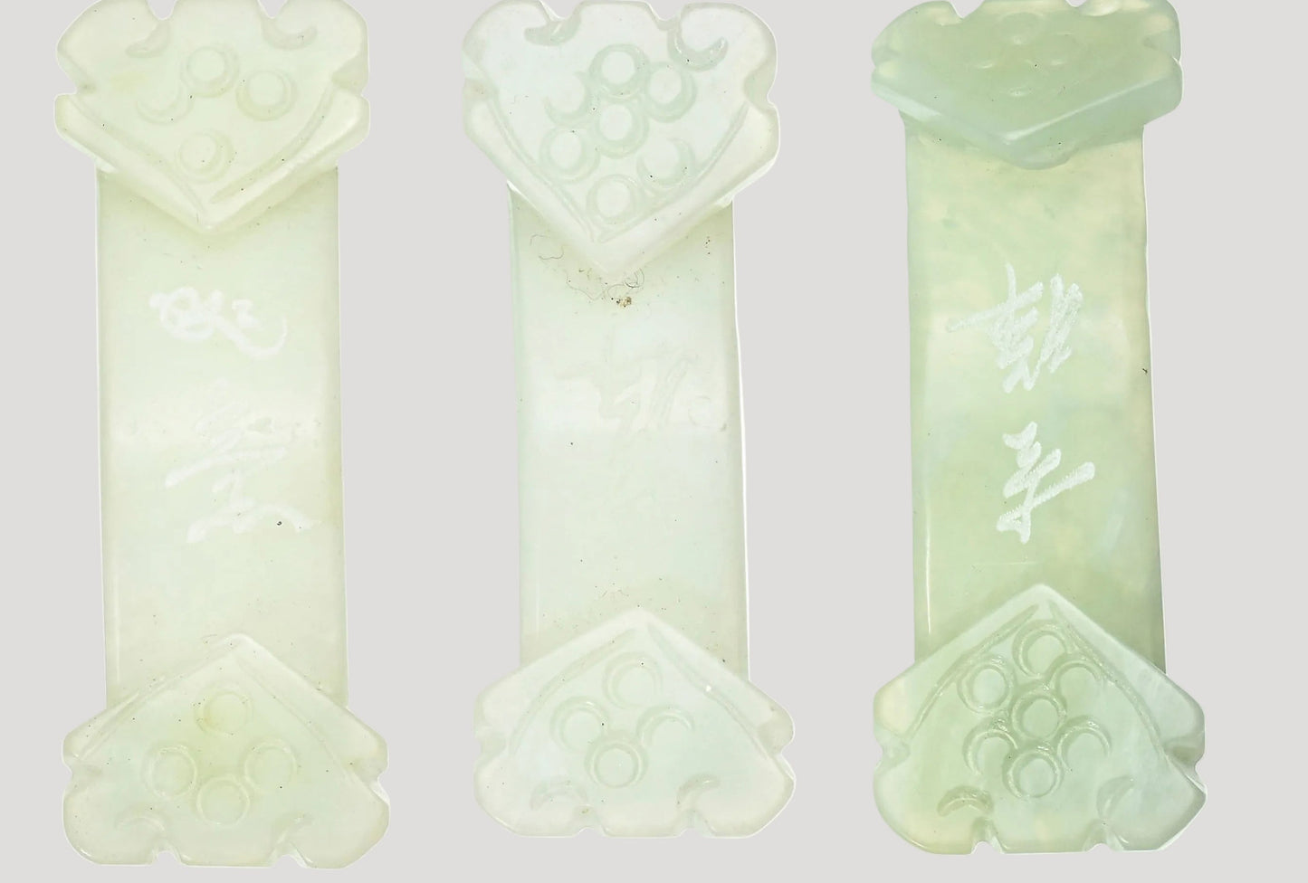 Set of 4 antique jade belt buckles, each adorned with two ruyi, with inscriptions